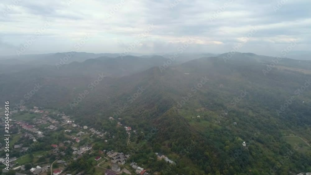 Aerial View: Flying over the small city covered by clouds. Aerial camera shot. Air clouds. 4k Aerial View: Flying over the small city covered by clouds. Aerial camera shot. Air clouds. 4k
