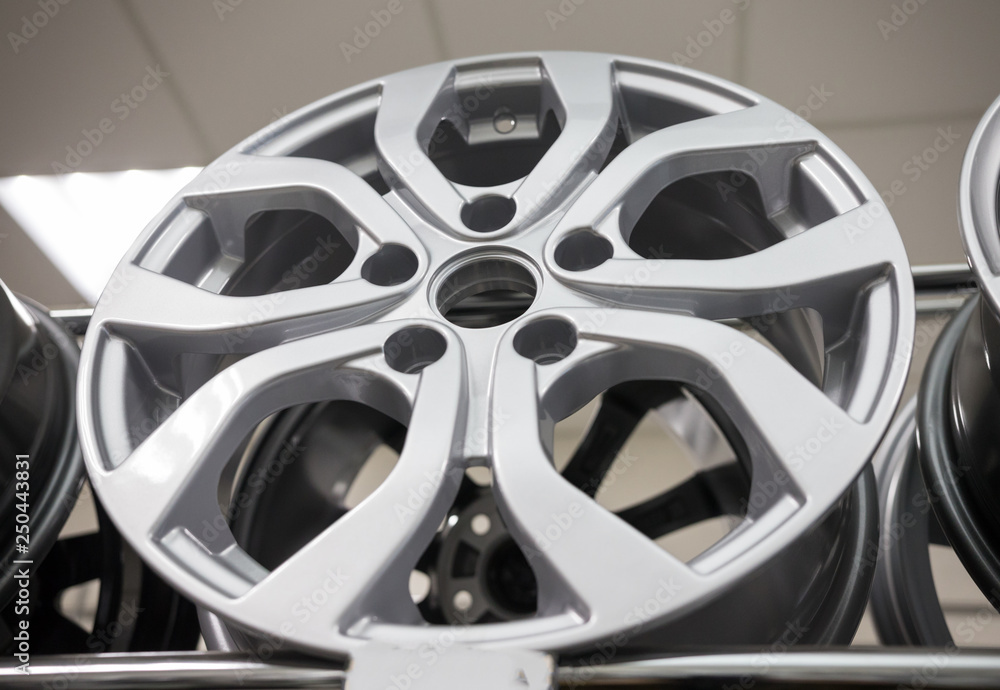 A car shop. Brand new clean white rim. View from below