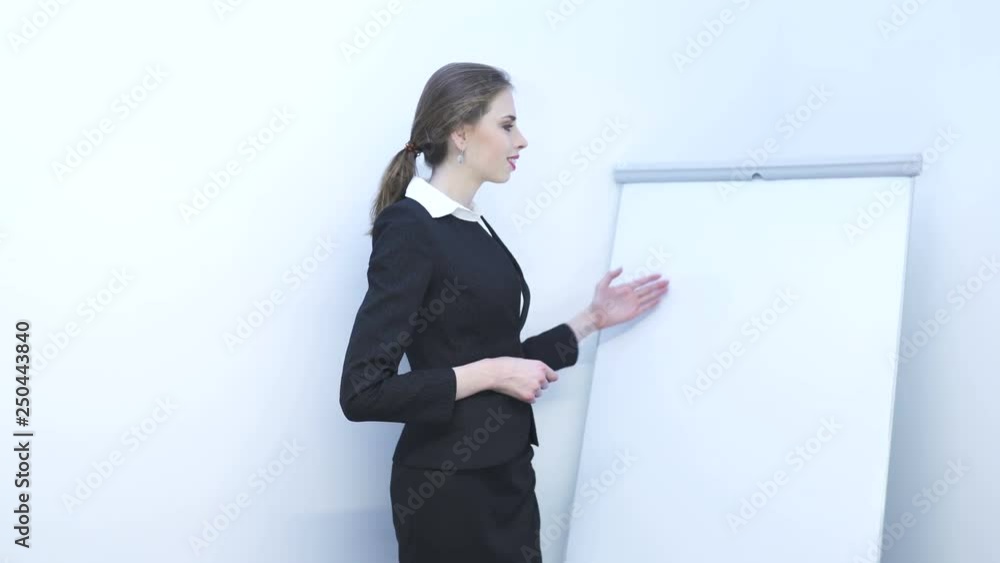       4K. Presentation  team.Pretty business woman  show something information ,using flipchart