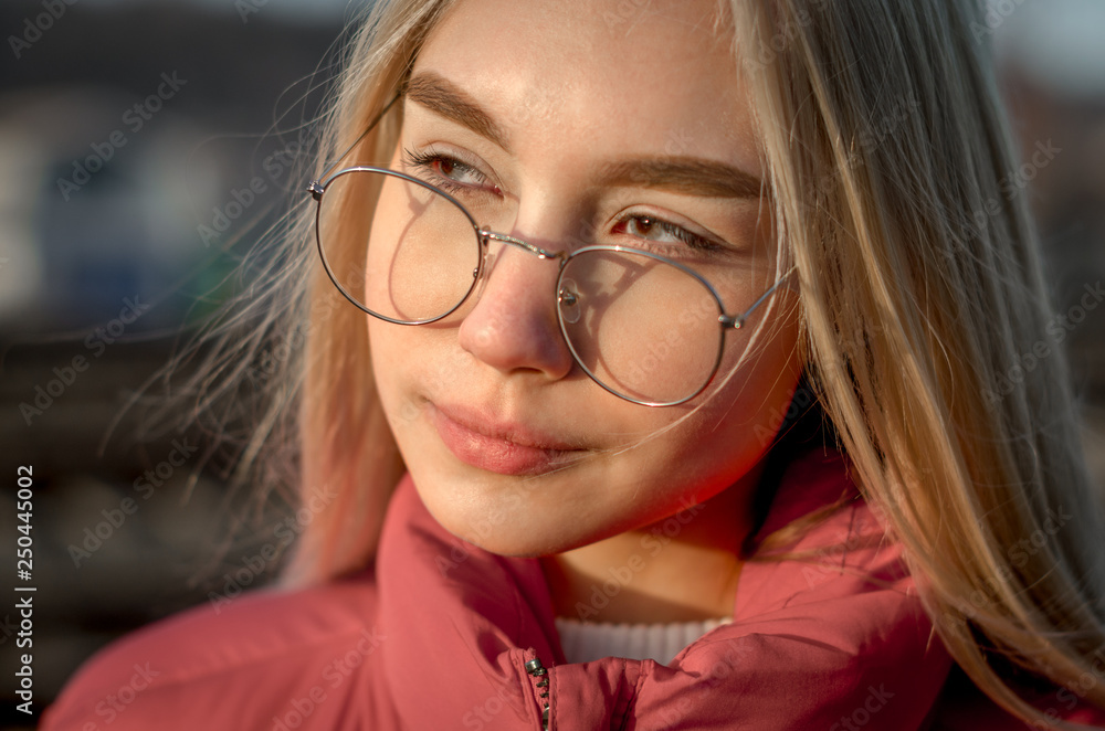 portrait of a young girl with blond hair with glasses close up portrait of a young girl with blond hair with glasses close up