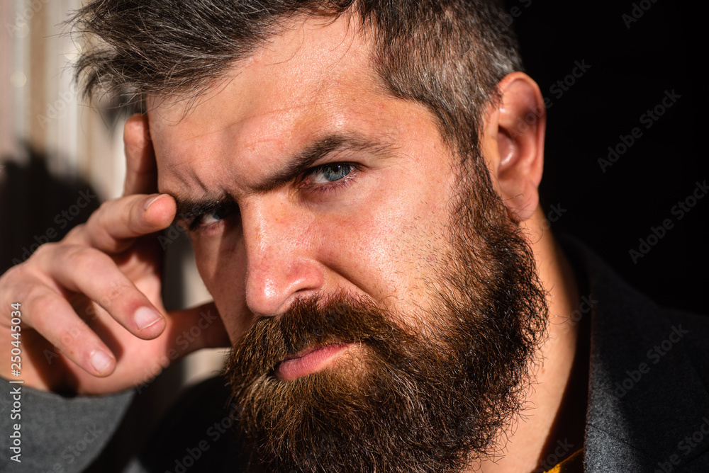 Obraz premium Serious man, confident look. Male face is close. Human portrait. Bearded guy.