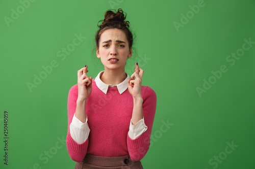 Portrait of a worried woman holding fingers