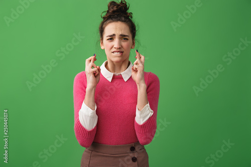 Portrait of a worried woman holding fingers photo