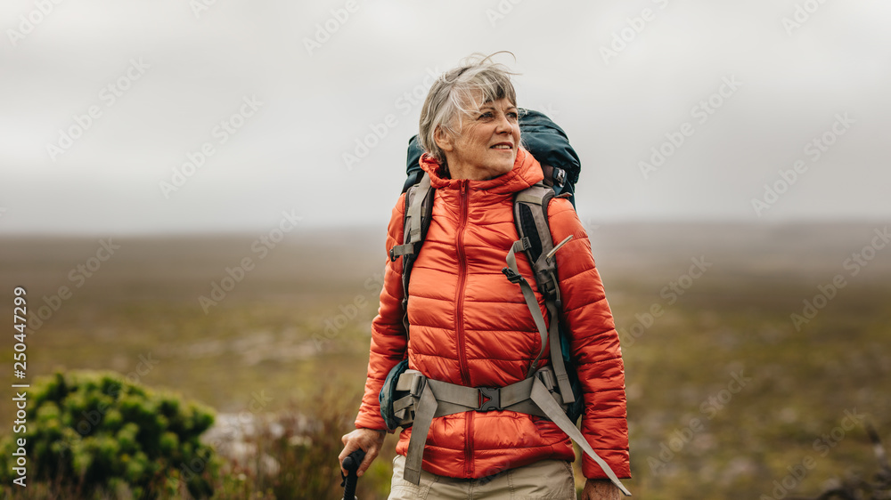 Senior woman on a hiking adventure - obrazy, fototapety, plakaty 