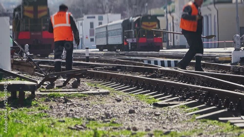 Train on the railroad and workers about the rail