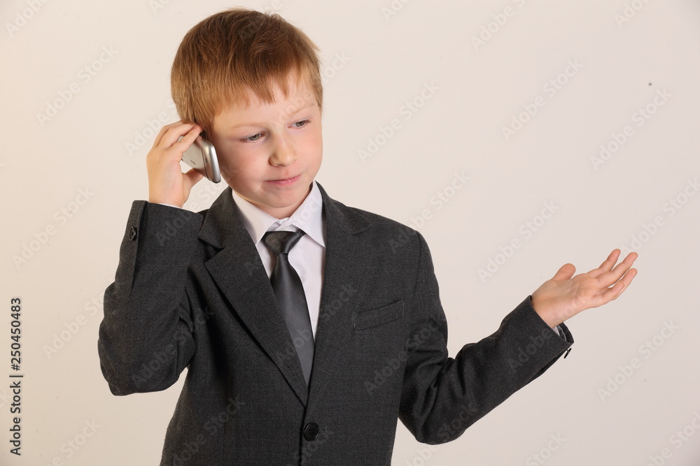 child with a phone, schoolboy with a phone, model, boy, school suit, young model child with a phone, schoolboy with a phone, model, boy, school suit, young model