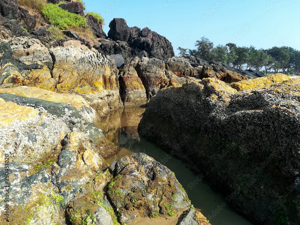 Natural channel in the rocks and blue sky