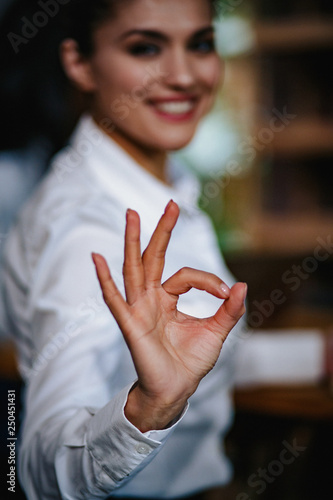 Selective focus on ok gesture from businesswoman