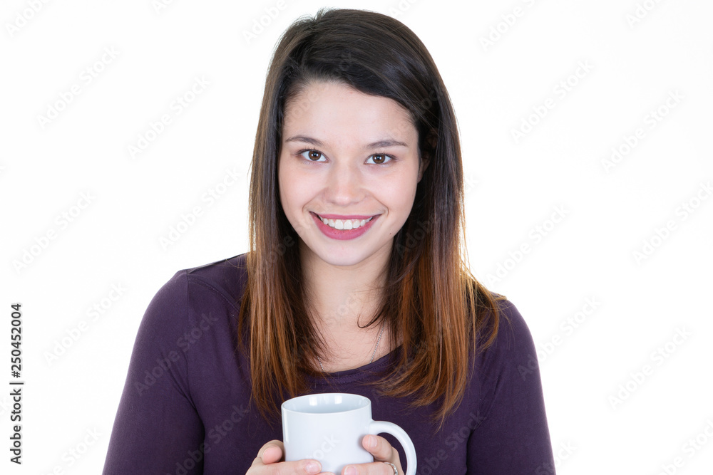 Beautiful young woman standing and holding white mug cup Beautiful young woman standing and holding white mug cup