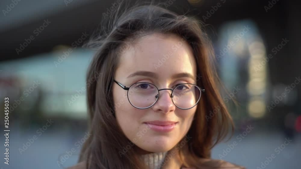 Slow motion attractive dreamy gorgeous brunette girlfriend wearing glasses contemplating evening sunset passersby, standing square city-center turning camera smiling lovely, happy urban lifestyle Slow motion attractive dreamy gorgeous brunette girlfriend wearing glasses contemplating evening sunset passersby, standing square city-center turning camera smiling lovely, happy urban lifestyle