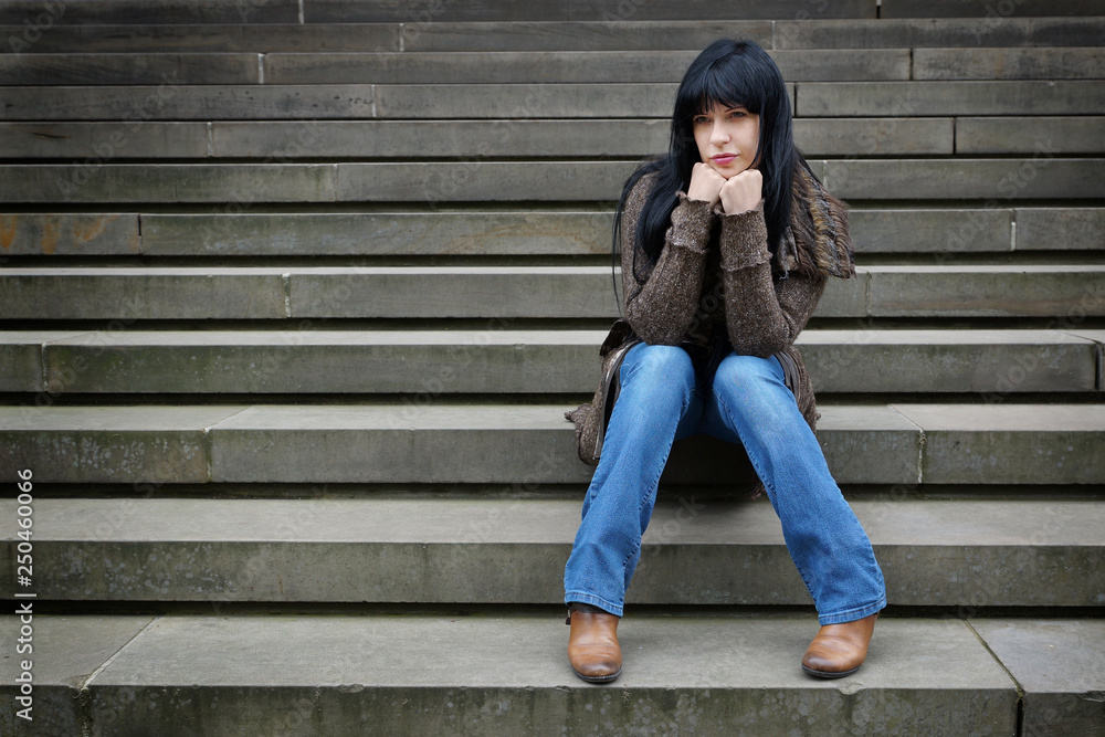 lonely young woman sitting on steps outside lonely young woman sitting on steps outside