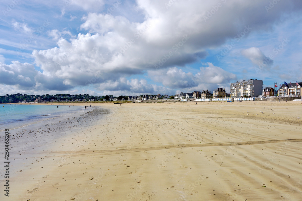 Beach under a cloudy sky in Saint-Cast-le-Guildo, a commune in the Côtes-d'Armor department of Brittany in northwestern France Beach under a cloudy sky in Saint-Cast-le-Guildo, a commune in the Côtes-d'Armor department of Brittany in northwestern France