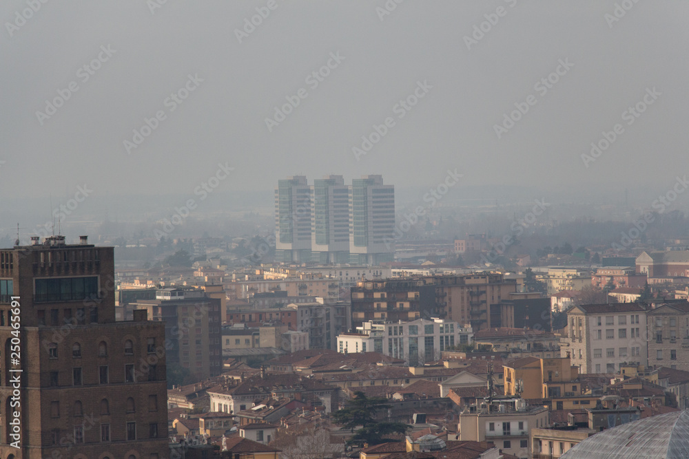 Brescia cityscape, buildings in fog, Lombardy, Italy.
