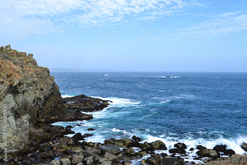 Sea cliffs in blue waters of the Pacific ocean Sea cliffs in blue waters of the Pacific ocean