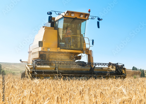 Harvester performing mowing tasks in the field.