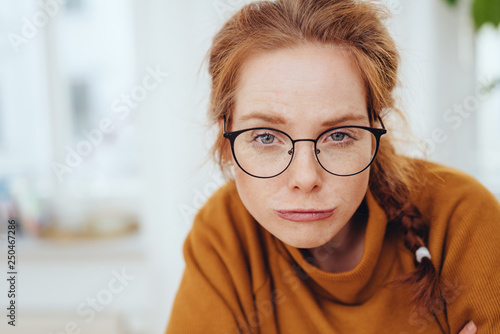Fototapet Funny portrait of pretty red-haired girl smirking