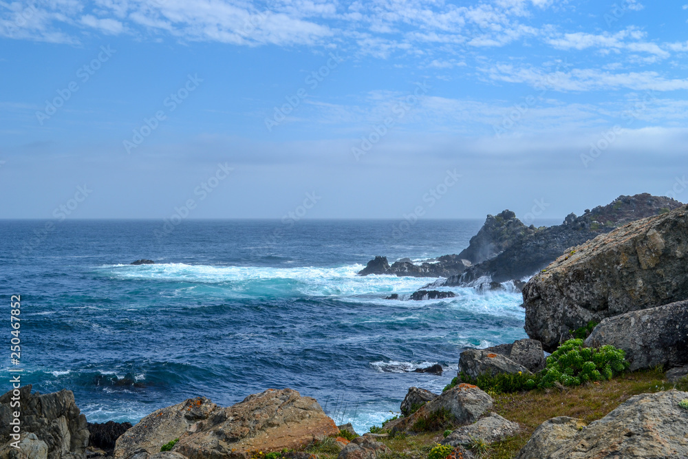 Sea cliffs in blue waters of the Pacific ocean Sea cliffs in blue waters of the Pacific ocean