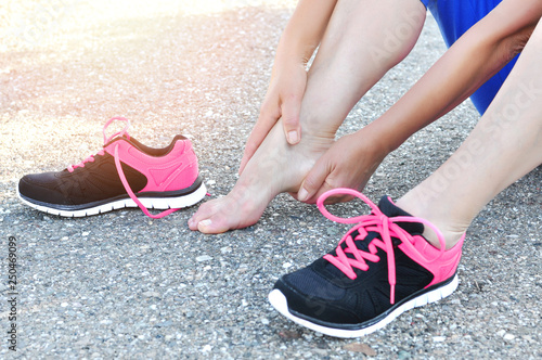 Muscle injury .Running injury leg accident- sport woman runner hurting holding painful leg. Athlete woman has muscle injury, sprained leg during running training in nature.