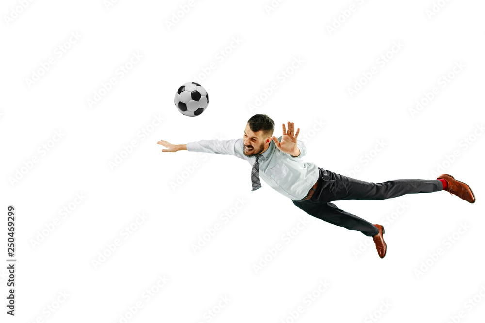Fototapeta premium Full length shot of a young businessman playing football isolated on white background.