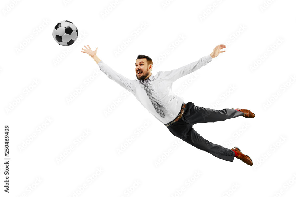 Fototapeta premium Full length shot of a young businessman playing football isolated on white background.