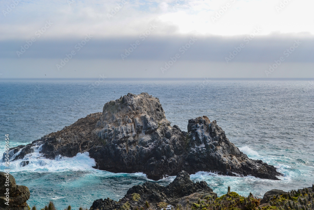Sea cliffs in blue waters of the Pacific ocean Sea cliffs in blue waters of the Pacific ocean