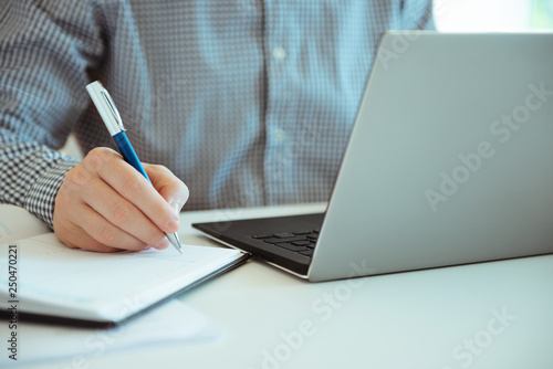 Closeup photo of man working with laptop