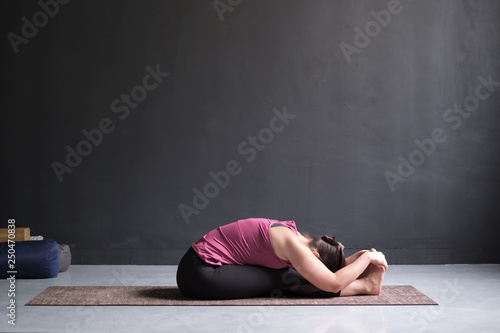 woman practicing yoga, Seated forward bend pose