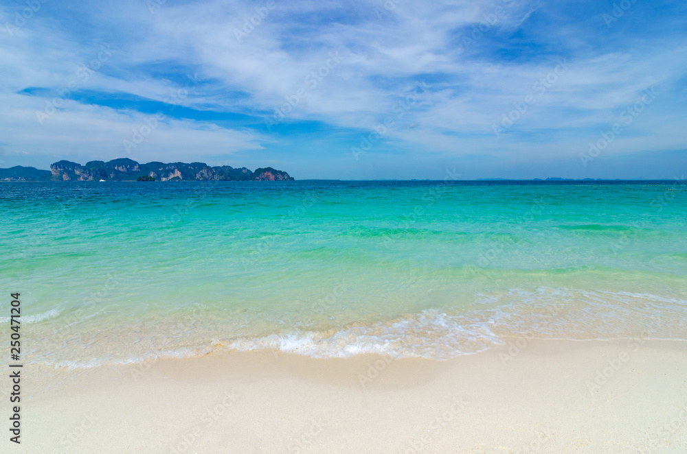 White beach on a clear blue sky, blue sea