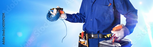 Electrician with tools and electrical equipment isolated with lights
