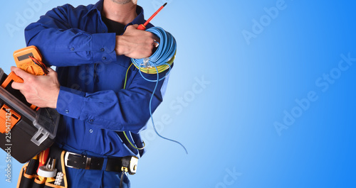 Electrician with tools and electrical equipment isolated blue detail