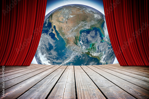Open theater red curtains against our wonderful Planet Earth - concept image with image from NASA