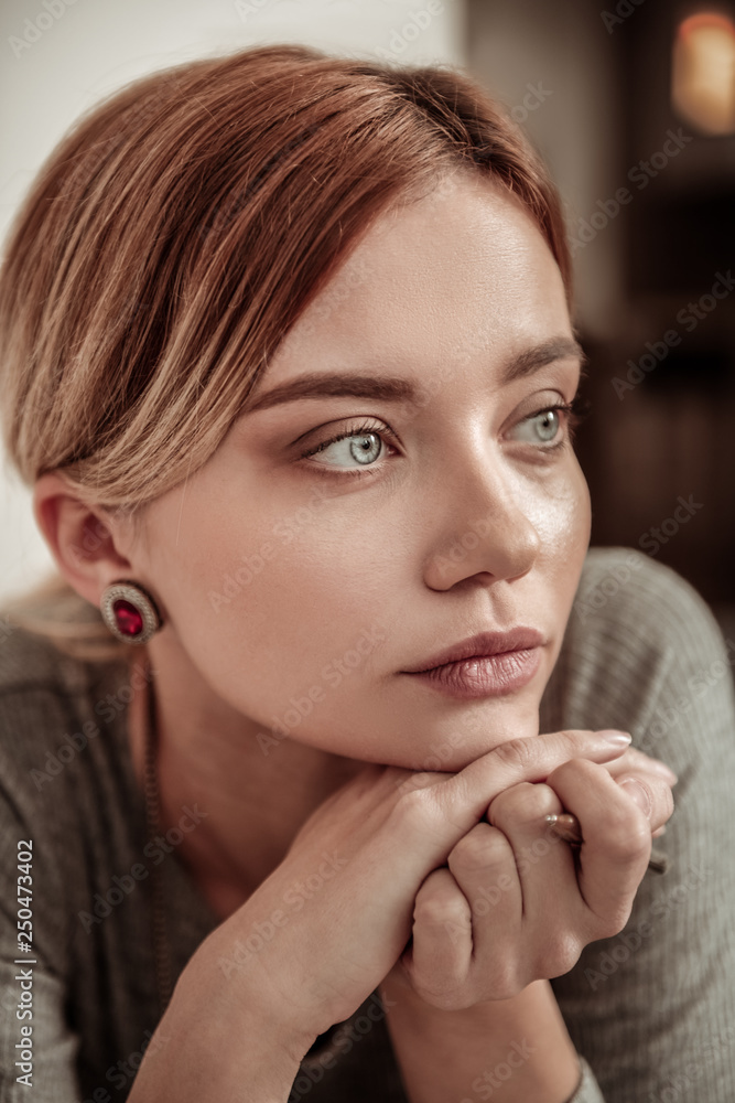 Portrait of beautiful young blue-eyed woman wearing stylish jewelry Portrait of beautiful young blue-eyed woman wearing stylish jewelry