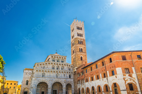 Duomo di San Martino San Martin cathedral facade and bell tower in historical centre of medieval town Lucca in beautiful summer day with blue sky background, Tuscany, Italy