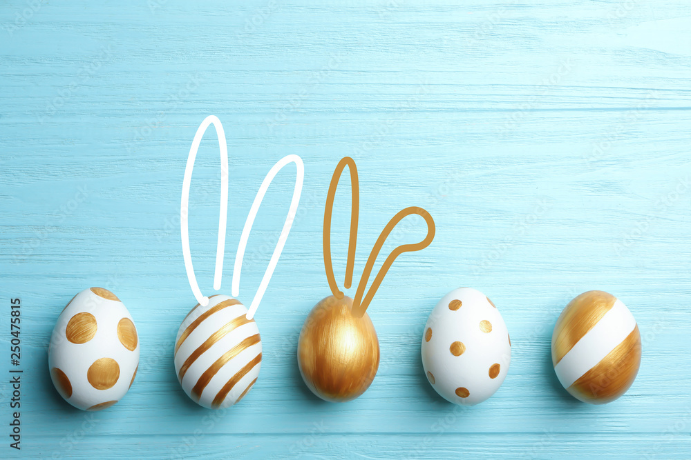 Set of traditional Easter eggs decorated with golden paint on wooden background, top view. Space for text