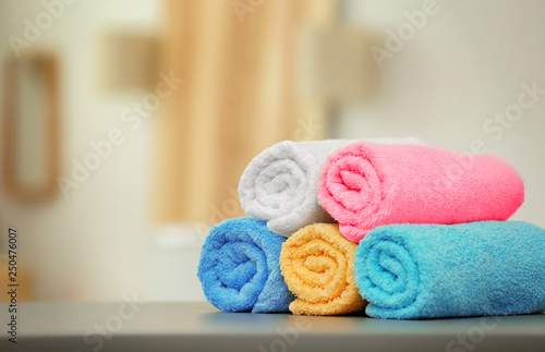 Clean towels on table against blurred background