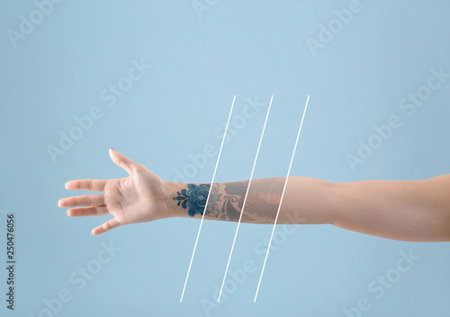 Canvas-taulu Female arm with tattoo on color background