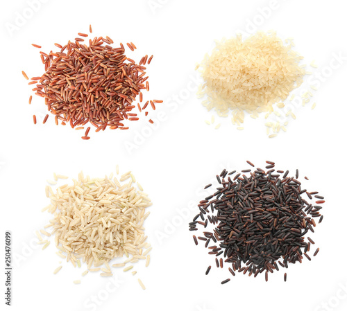 Set with piles of different uncooked rices on white background, flat lay