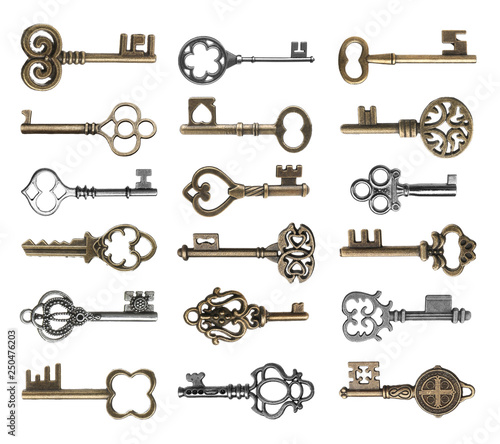 Set of vintage ornate keys on white background