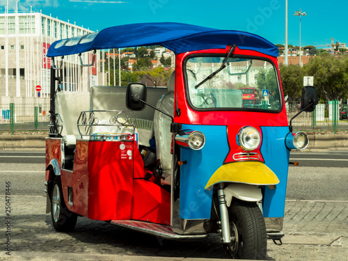 Motorcycle for walking in Lisbon. Bright tuk-tuk motorcycle