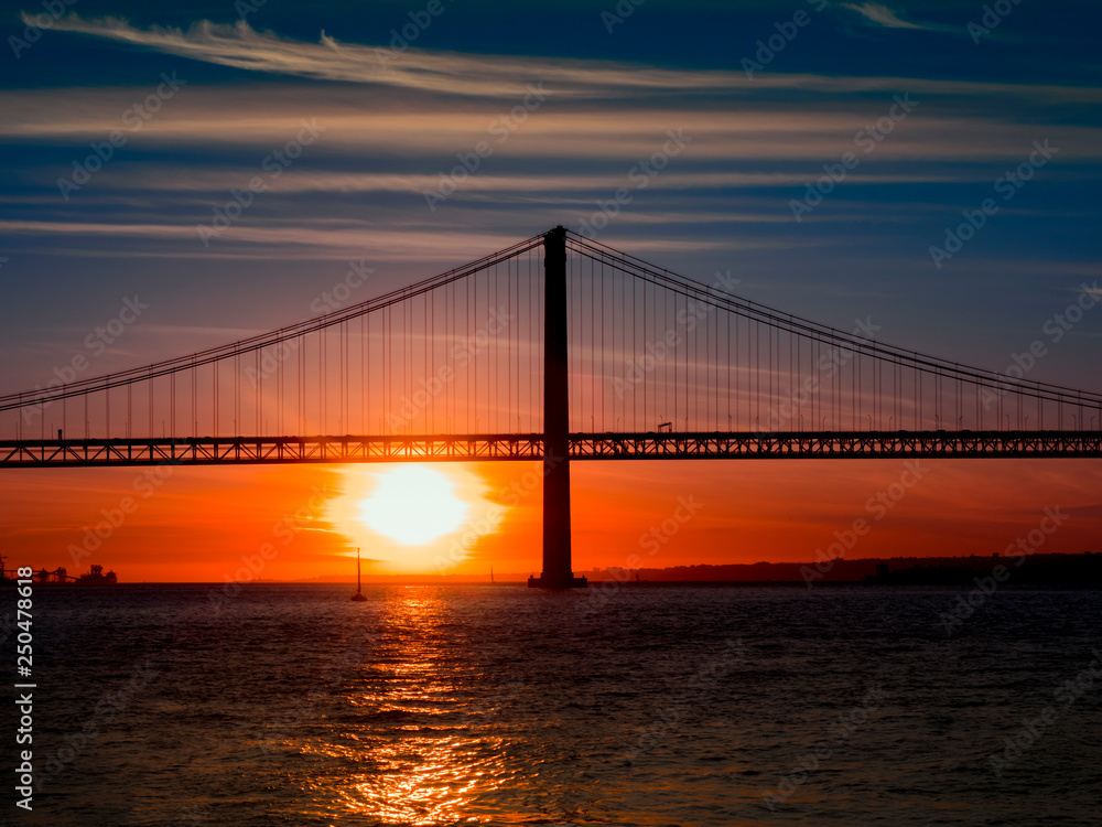 Bridge April 25 over the river Tejo. Sunset in Lisbon. Famous bridge of lisbon Bridge April 25 over the river Tejo. Sunset in Lisbon. Famous bridge of lisbon