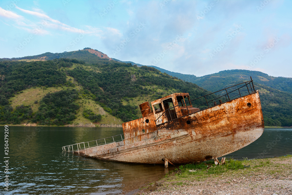 old rusty abandoned boat on lake old rusty abandoned boat on lake