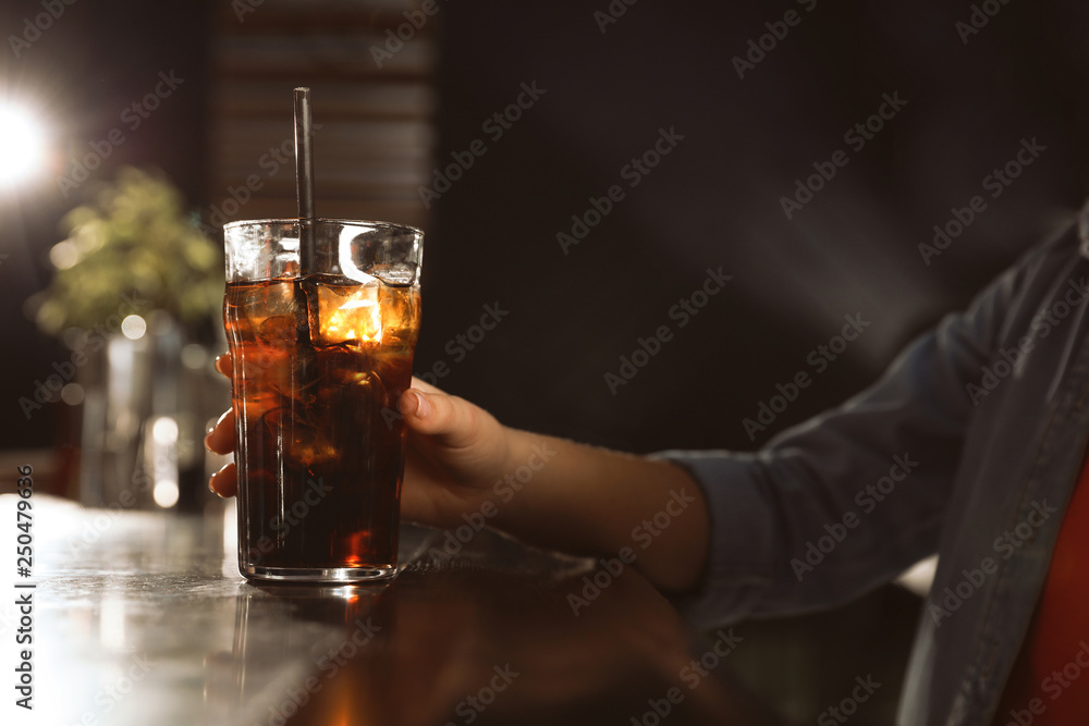 Woman with glass of refreshing cola at bar counter, closeup Woman with glass of refreshing cola at bar counter, closeup