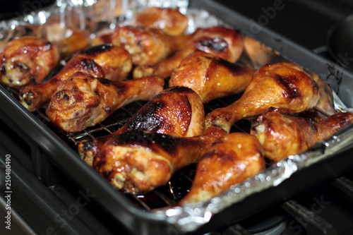 Freshly baked barbecue chicken drumsticks from the oven.