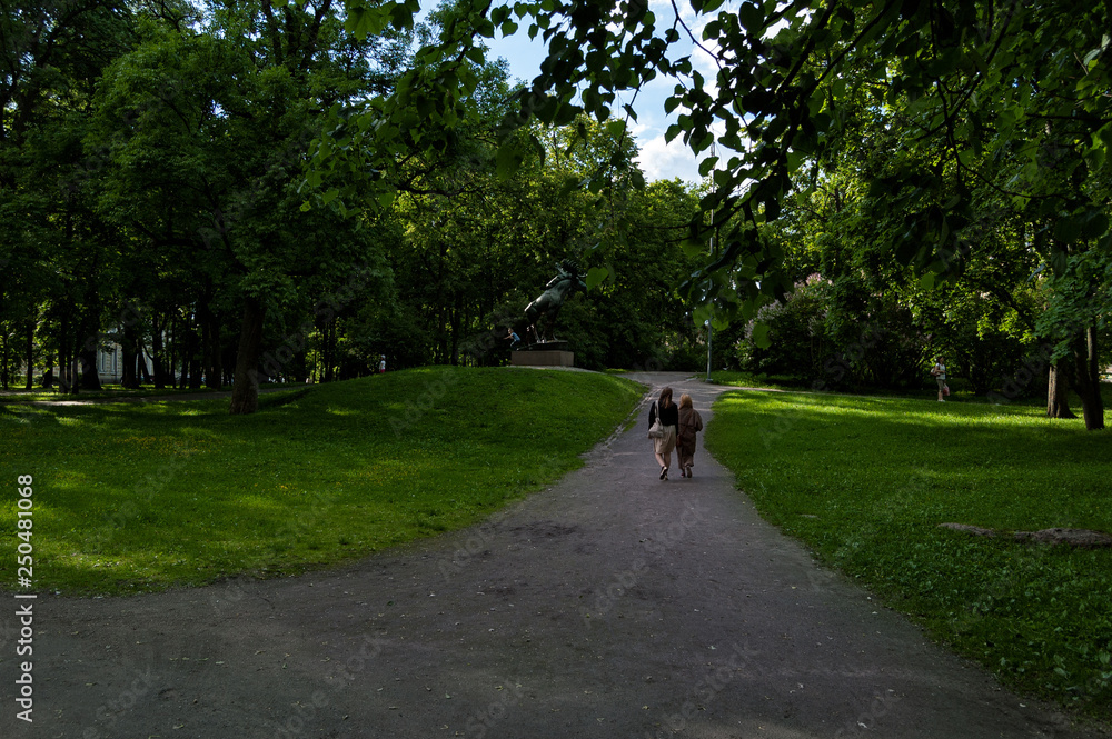 Park with sculpture and two people staring at Park with sculpture and two people staring at