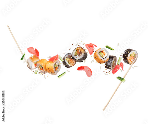 Fresh different sushi rolls with ginger frozen in the air on white background