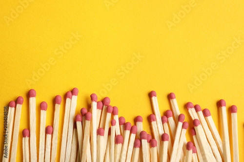 Wooden matches on color background, flat lay. Space for text