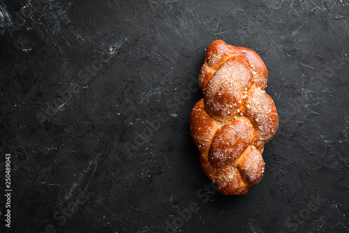 Obraz na plátně Braided bread with flour. Top view. Free space for your text.