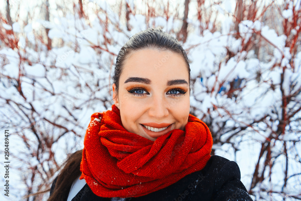 Young beautiful woman in winter park or forest making selfie. Young beautiful woman in winter park or forest making selfie.
