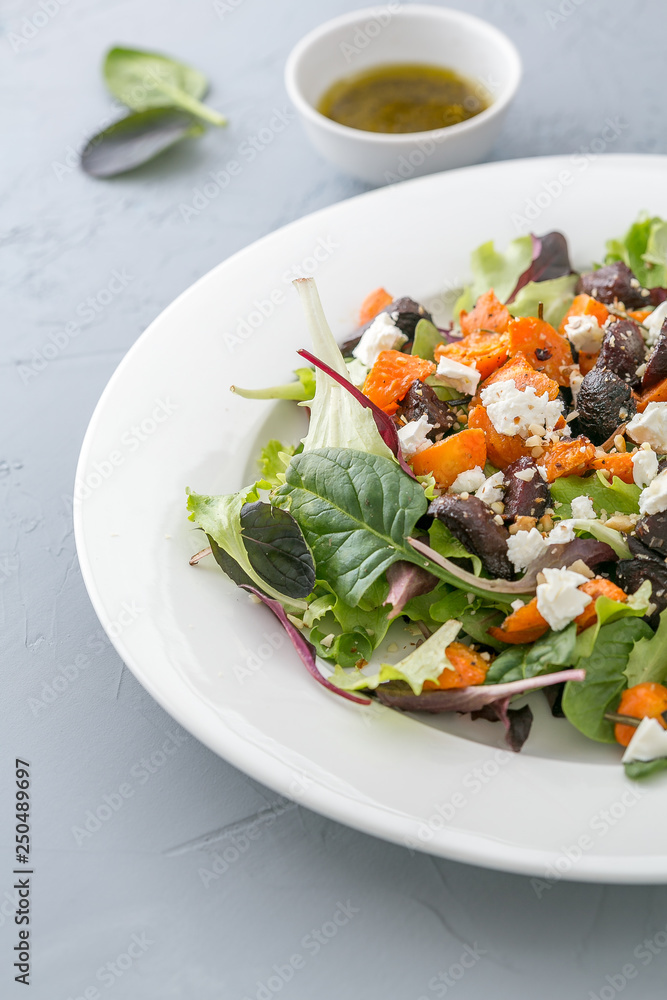 Baked beet and carrot salad with cheese. close up, selective focus Baked beet and carrot salad with cheese. close up, selective focus