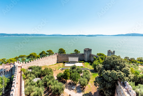 Castiglione del Lago medieval fortress fort in Umbria, Italy Rocca with Medievale o Rocca del Leone tower and lake Trasimeno high angle view in sunny summer day by amphitheater